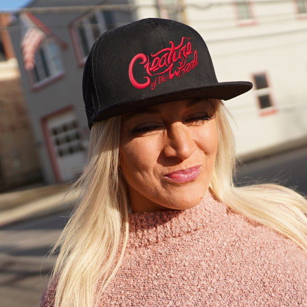 Creature of the Wheel hand-lettered hat worn by woman