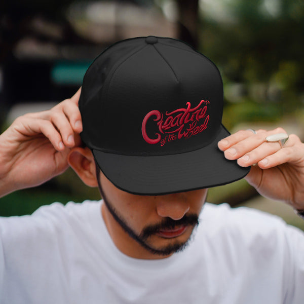 Creature of the Wheel hand-lettered hat worn by male