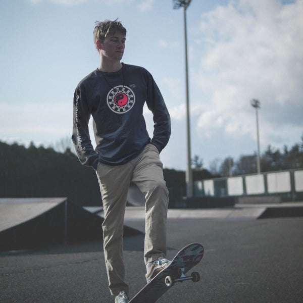 Male skater wearing Moral Compass long sleeve tshirt